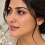 Woman wearing Love Spark Lab Grown Diamond Nose Ring, a delicate heart-shaped diamond hoop in yellow gold.