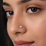 Heart shaped diamond nose pin in yellow gold worn on a model
