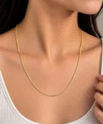 Woman wearing a premium 18K yellow gold chain with a sleek and refined link design