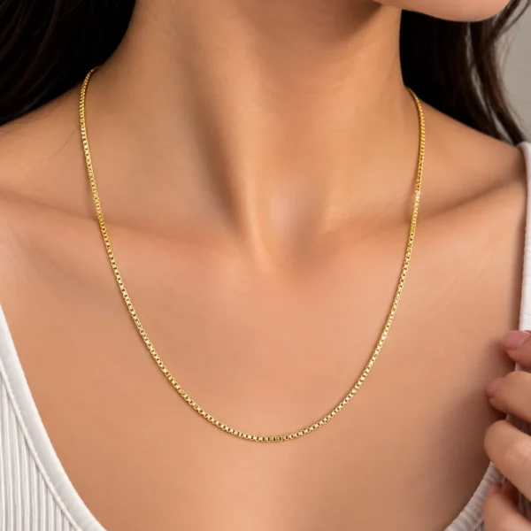 Woman wearing a premium 18K yellow gold chain with a sleek and refined link design