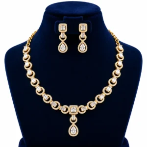 18K Gold Baguette Cut Lab Grown Diamond Halo Necklace Set with Matching Earrings featuring sparkling rectangular baguette diamonds, circular diamond halo links, square diamond centrepiece and elegant pear-shaped drop pendant on a navy blue jewellery display.
