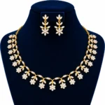 18K gold floral vine lab grown diamond necklace set with marquise diamond leaves, dangling flower clusters and matching earrings on navy blue jewellery bust