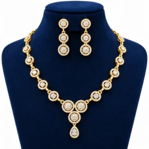 18K Gold Halo Lab Grown Diamond Necklace Set with Matching Earrings featuring sparkling round halo diamond designs, elegant teardrop pendant and premium yellow gold finish displayed on a navy blue jewellery stand.