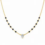 18K gold pear cut solitaire lab grown diamond mangalsutra with traditional black beads and delicate yellow gold chain on white background