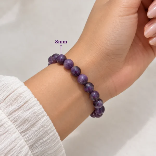 8mm Amethyst Serenity Crystal Bracelet with small polished purple crystal beads worn on a woman's wrist.