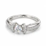 Angled side view of Bow Moissanite 925 Sterling Silver Ring featuring a round centre stone and curved pavé side detailing.
