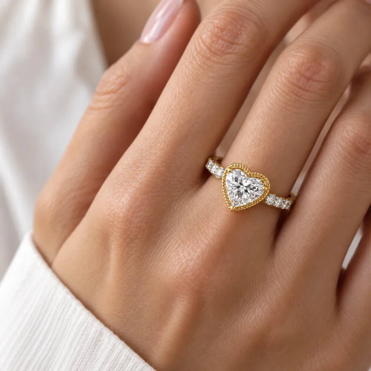 Eternal Love heart cut lab grown diamond ring in 18K gold worn on a woman's finger.