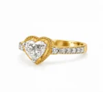 Eternal Love heart-shaped lab grown diamond ring in gold with pavé diamond band, side angle view.