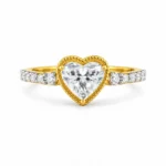 18K gold heart cut lab grown diamond ring with decorative heart setting and sparkling side diamonds, front view.