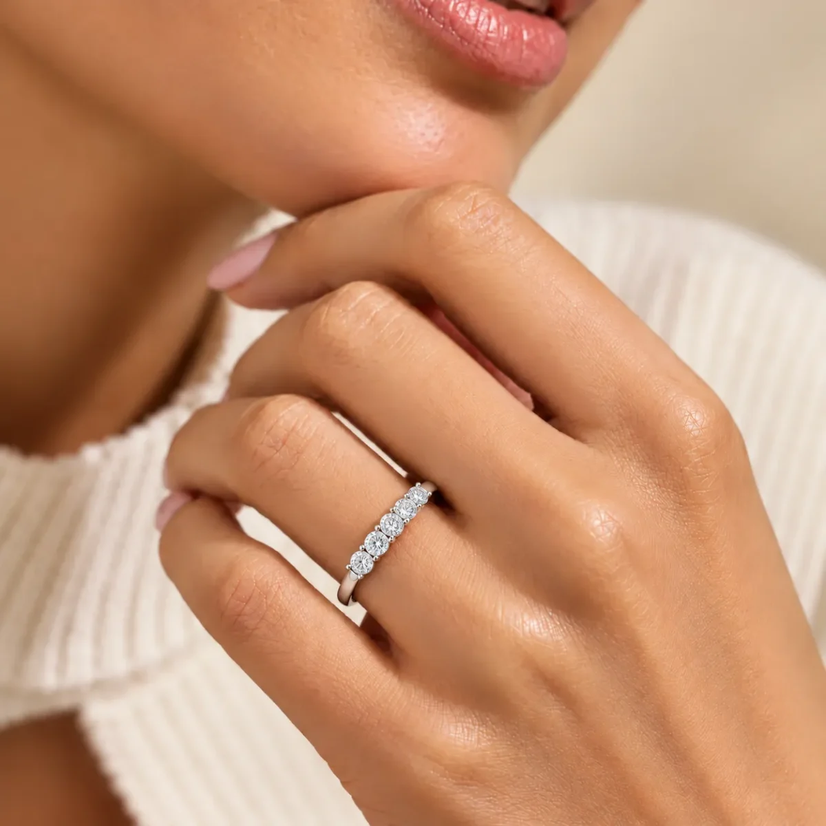 Five Wishes Moissanite Diamond Ring worn on woman's finger featuring five sparkling round-cut stones in a silver setting.