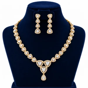 18K gold trillion cut lab grown diamond halo necklace set with triangular diamond motifs, central dangling pendant and matching earrings on navy blue jewellery bust