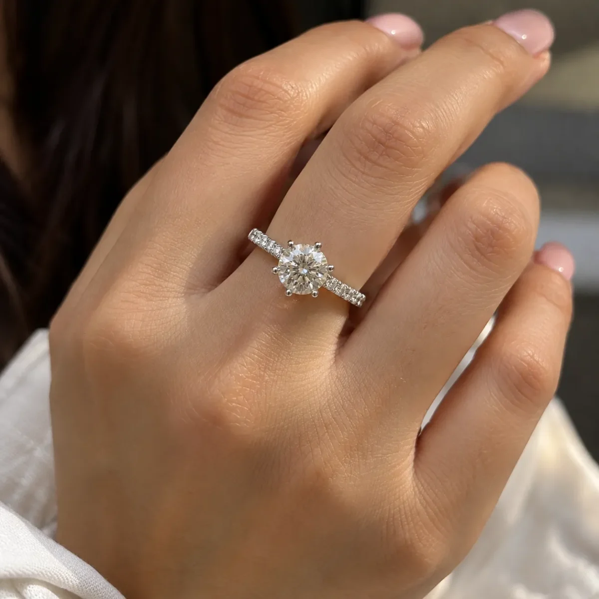 Radiant Solitare Lab Grown Diamond Solitaire Ring worn on a woman's finger with round diamond and pavé band