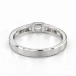 Back view of Regal Emerald Moissanite Men's Ring showcasing the silver inner band, emerald-cut stone setting and detailed craftsmanship.