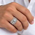 Royal Sunburst Moissanite Diamond Men's Ring in 925 Sterling Silver with rose gold finish, featuring four round-cut Moissanite stones in a square sunburst design, worn on a male model's finger.