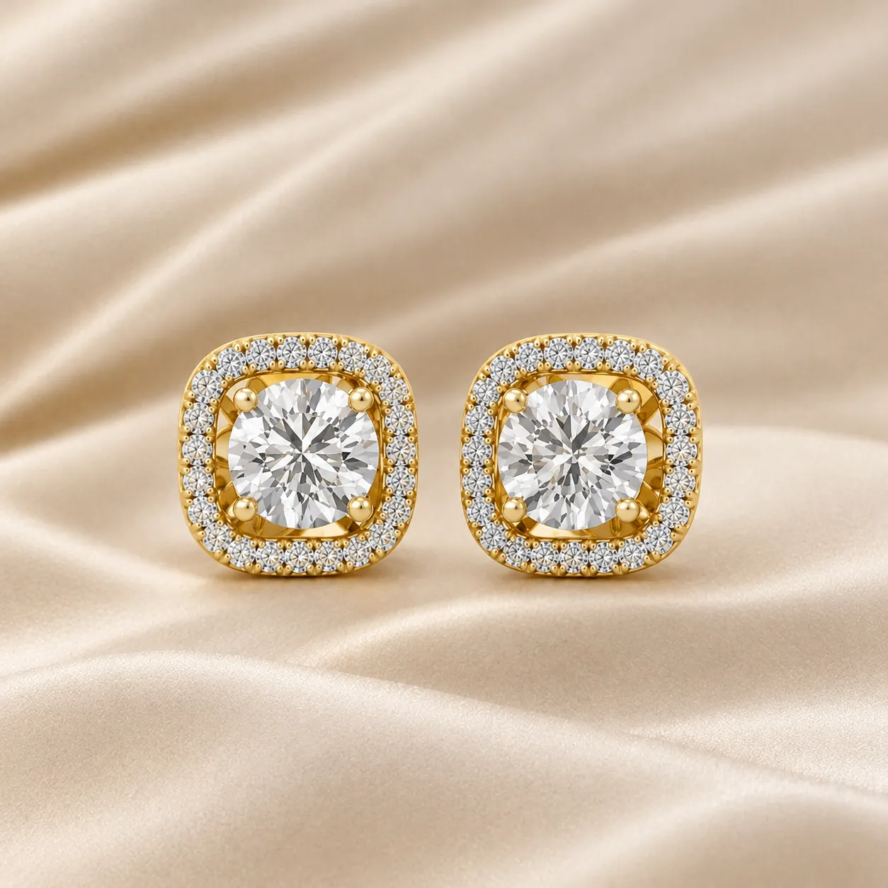 Gold diamond stud earrings with round-cut stones and halo setting